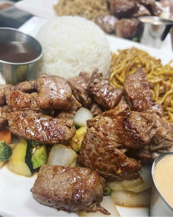 Hibachi steak with white rice, noodles, vegetables and dipping sauces